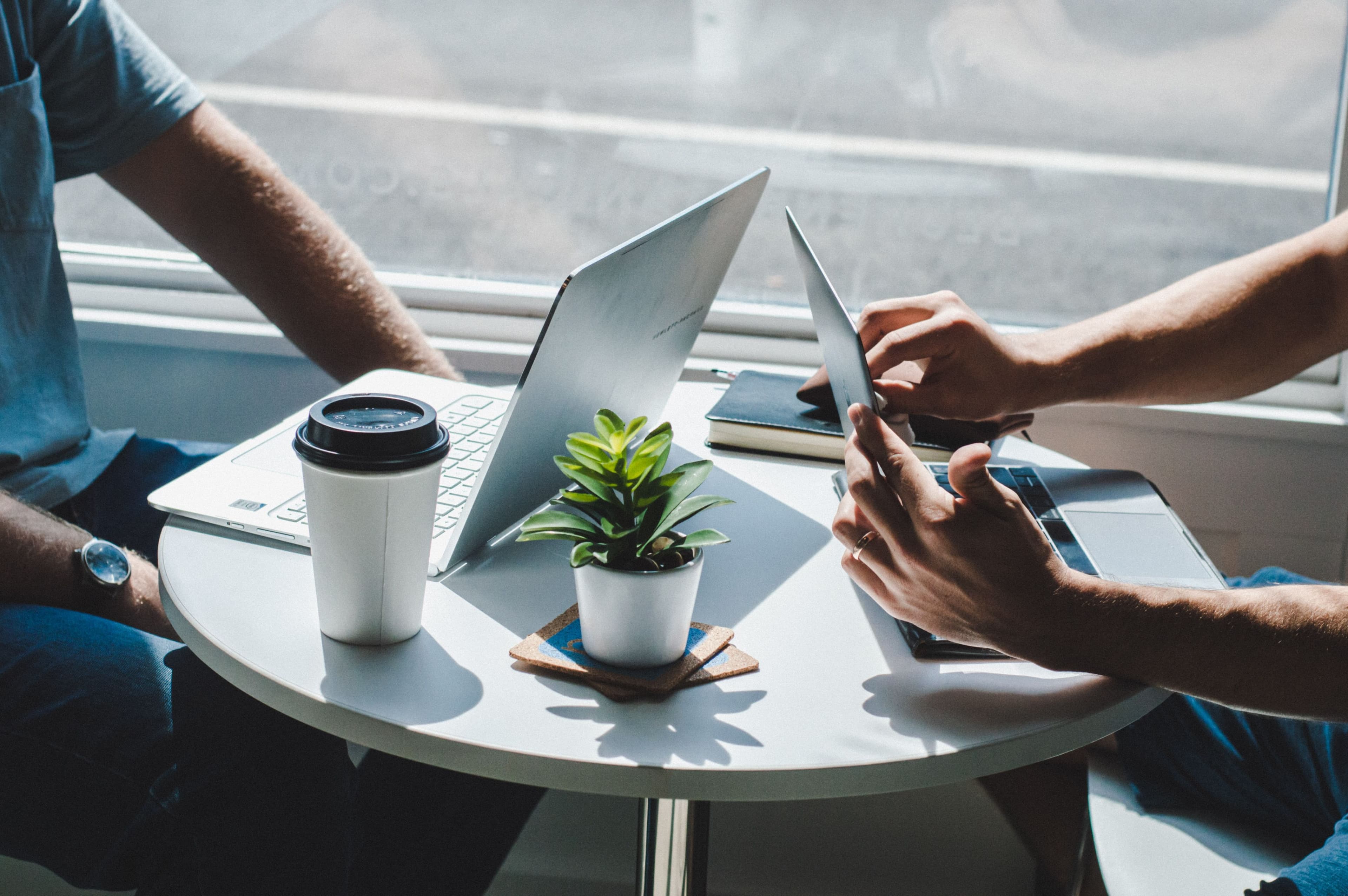 Laptop and coffee on a meeting table